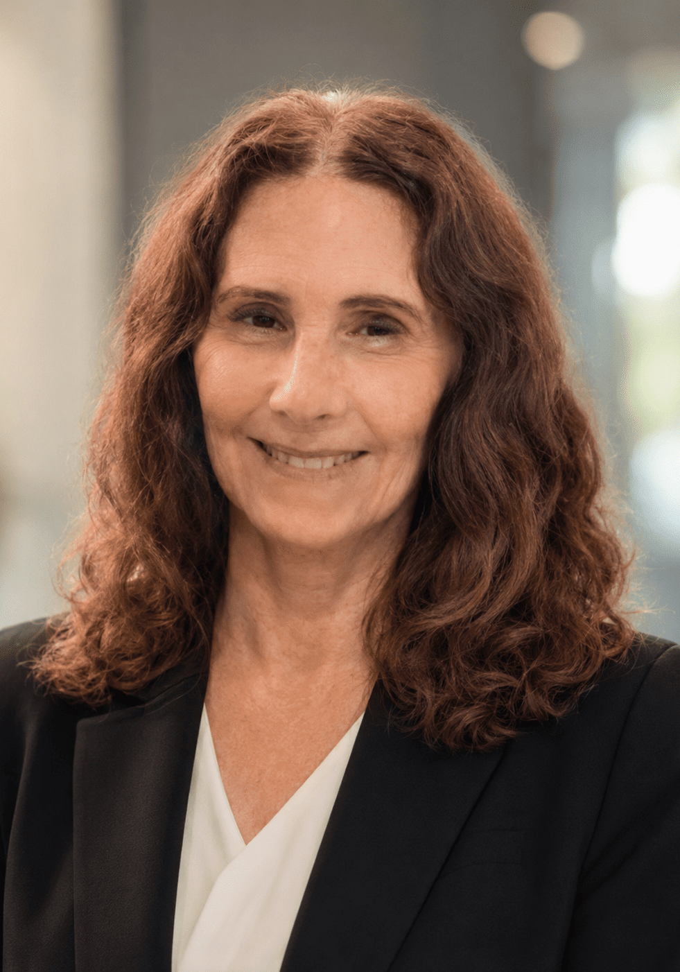 Smiling professional woman with curly brown hair